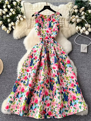 Vibrant floral midi dress with pleated skirt and tie waist.