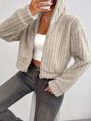 Beige textured teddy zip-up hoodie with a cropped length and ribbed details.
