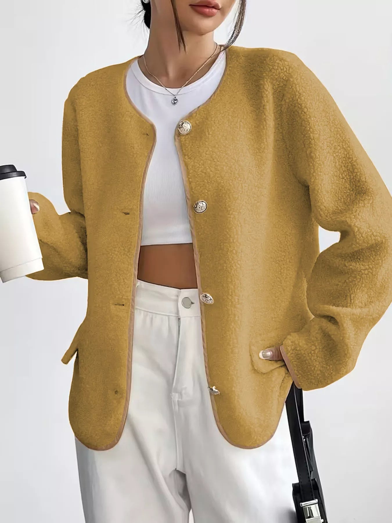 Textured button-up fleece jacket in mustard yellow with ornate buttons and round neckline.