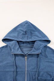 Dusty blue corduroy bomber hoodie with zipper and drawstring hood.