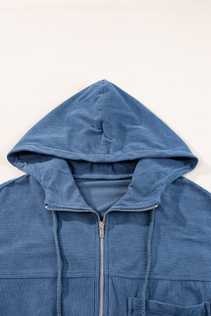Dusty blue corduroy bomber hoodie with zipper and drawstring hood.