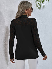 Black lace inset blouse with long sleeves and a high neckline.