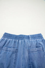 Maternity jeans in light blue denim with elastic drawstring waist and patch pockets.
