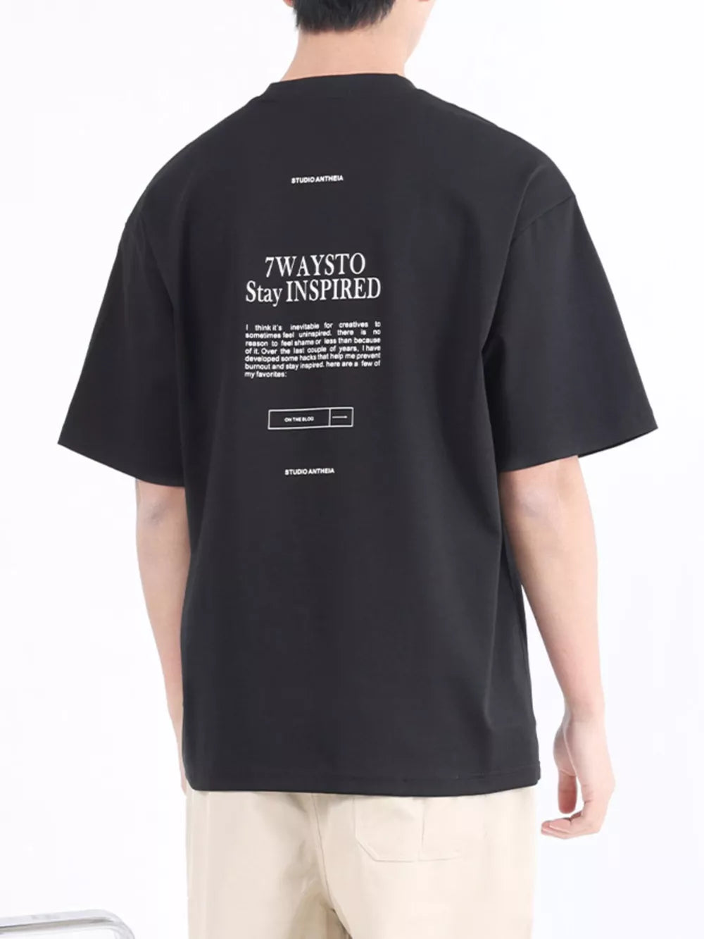 Black cotton blend crew neck t-shirt with white graphic text and logo on back.