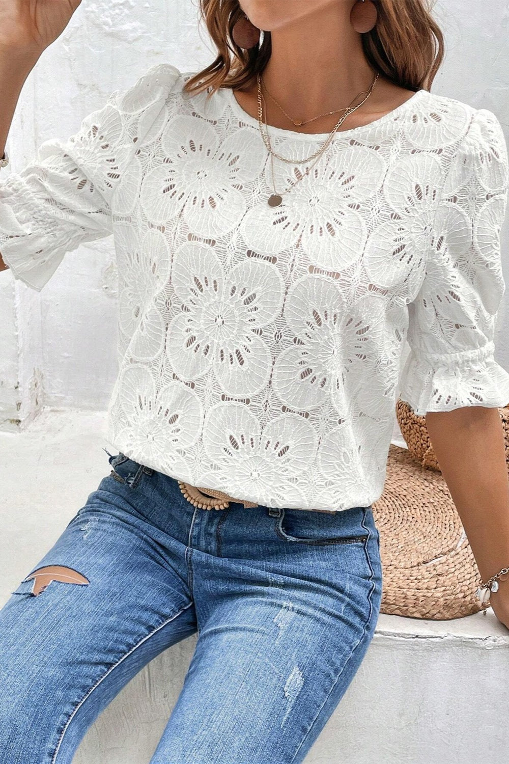 White eyelet blouse with puff sleeves and floral pattern
