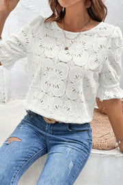 White eyelet blouse with puff sleeves and floral pattern
