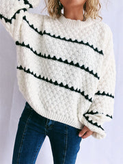 White acrylic knit jumper with black chevron stripes and textured diamond pattern.
