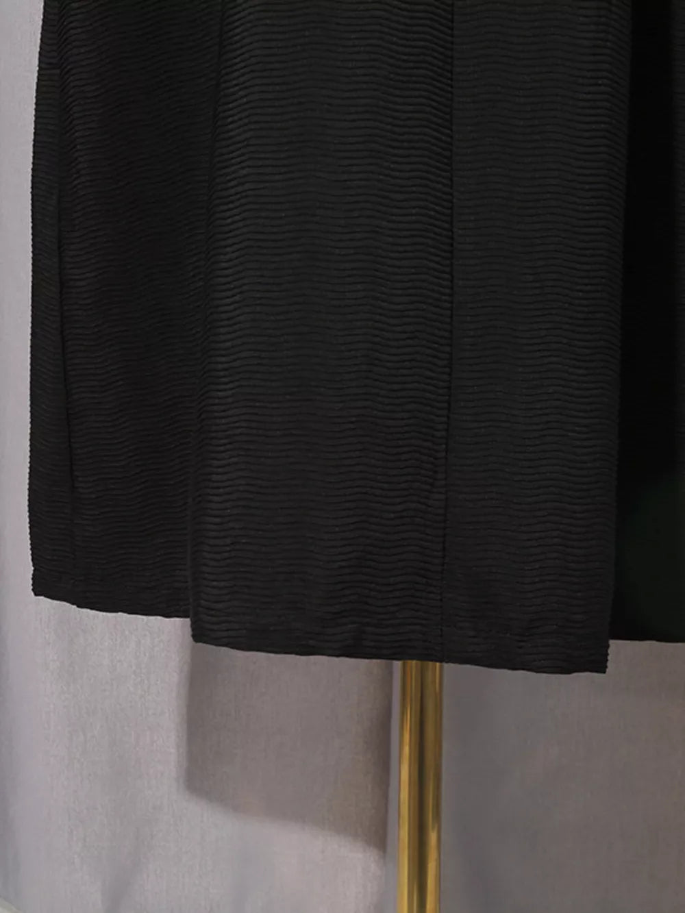 Black textured midi dress with a-line cut and puff sleeves.