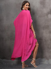 Hot pink asymmetrical flowing cover-up with a draped silhouette and high-low hem.