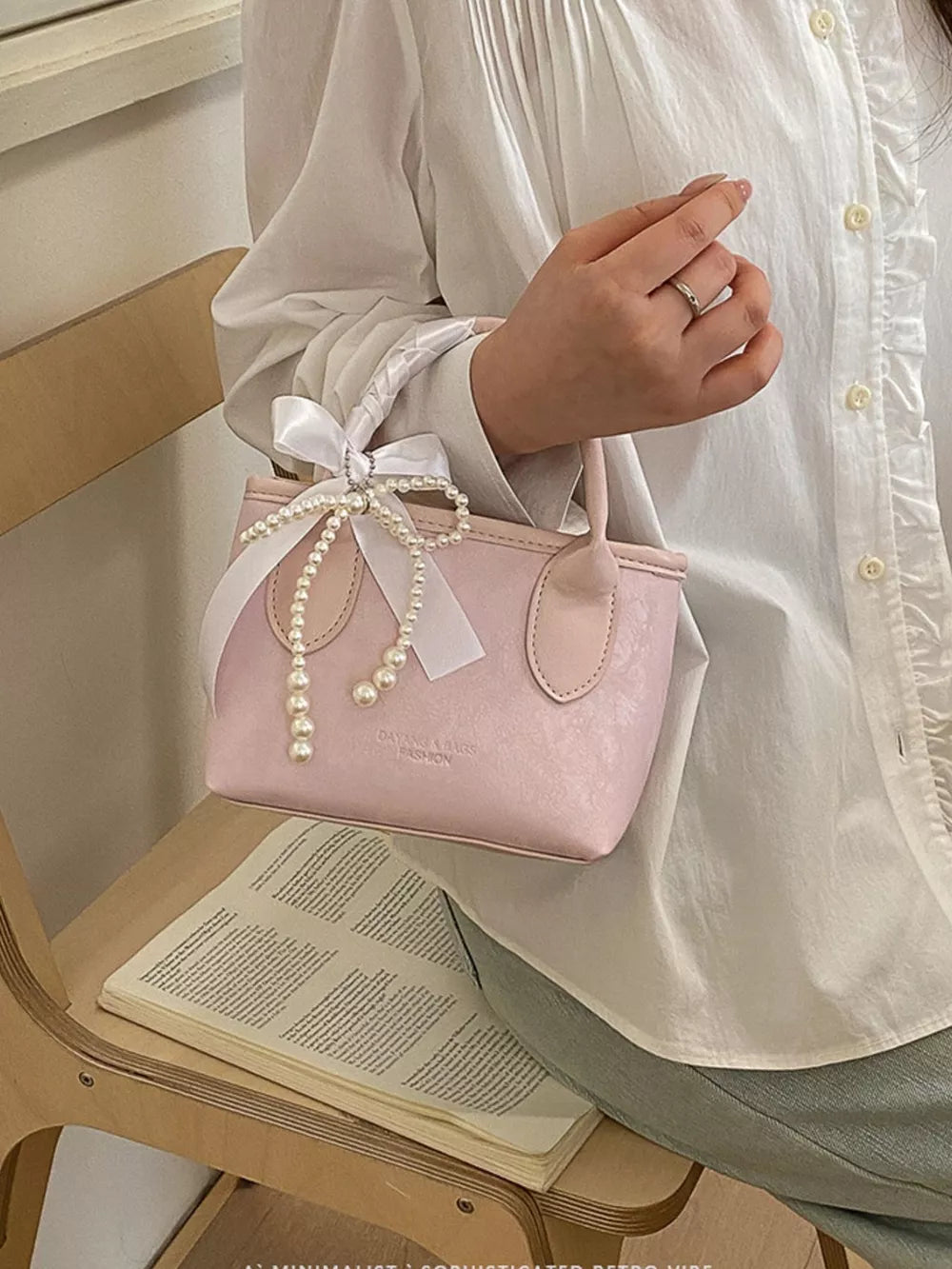 Pearl Bow Charm Crossbody Bag in Blush Pink, side view