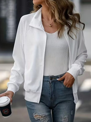 White ribbed zip-up track jacket with raglan sleeves and a stand-up collar.