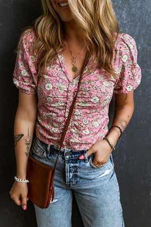 Floral ruched bodice puff sleeve top with a v-neckline.