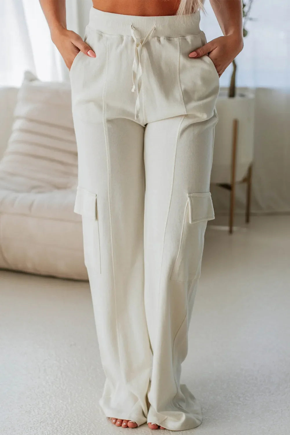 Ivory wide leg cargo pants with drawstring waist and cargo pockets
