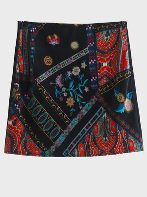 Black velvet patchwork mini skirt with colorful floral embroidery and paisley print.