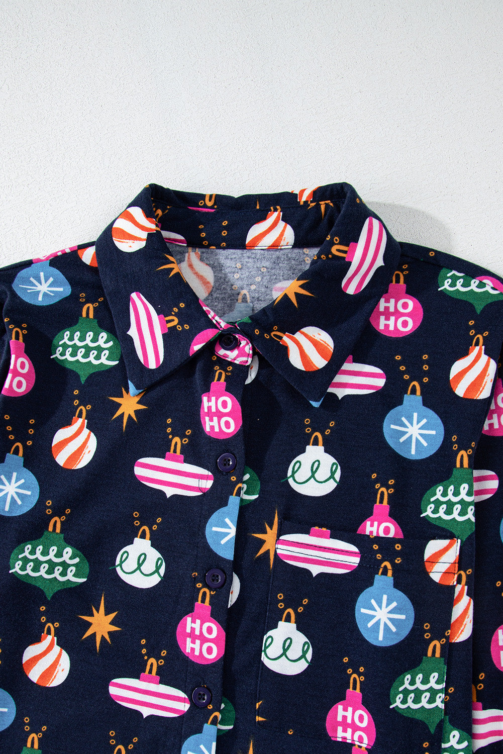 Navy blue loungewear set with festive bauble print, featuring a collared neckline and button-up front.