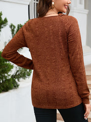 Textured knit top in chestnut with raglan sleeves and a crew neck.