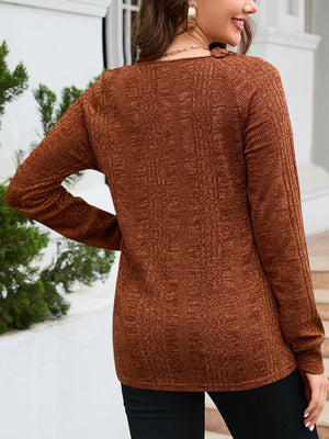 Textured knit top in chestnut with raglan sleeves and a crew neck.