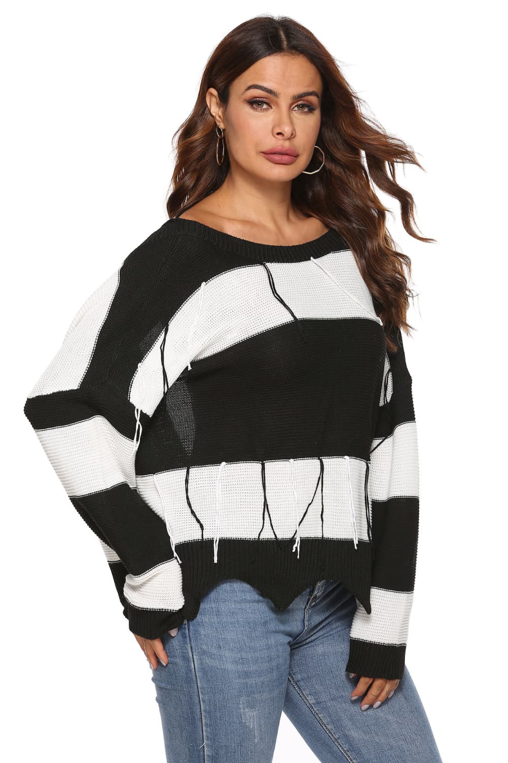 Stripe knit sweater with boat neck, frayed hem, and open-back detail.