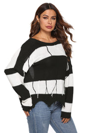 Stripe knit sweater with boat neck, frayed hem, and open-back detail.