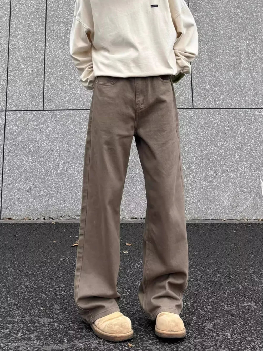 Men's brown wide-leg sweatpants with a relaxed fit and elastic waistband.