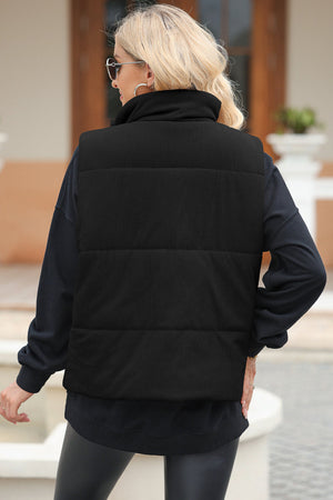 Black corduroy padded funnel neck vest with horizontal quilting.
