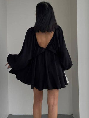 Black ruched V-neck dress with balloon sleeves and a low back