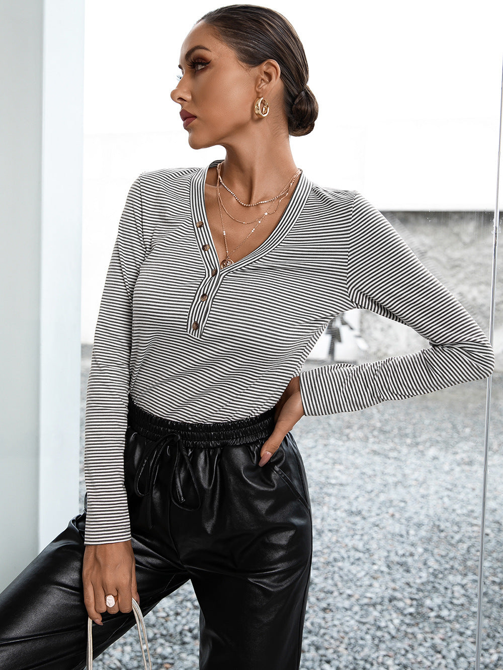 Ribbed Henley stripe top in gray with button detail and long sleeves.
