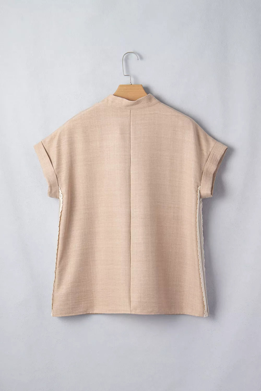 Beige crochet lace pullover with rolled sleeves and mock neck.