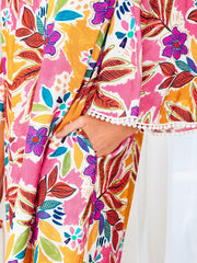 Print bell sleeve mini dress with colorful floral pattern and pom-pom trim detail.