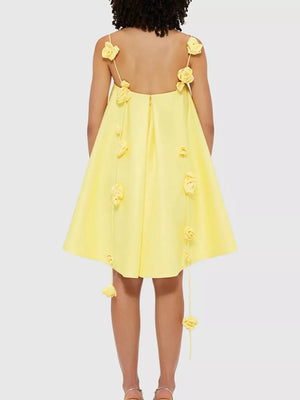Yellow A-line mini dress with floral applique details on straps and hem.