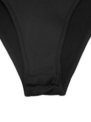 Black sheer bodysuit with lace panels and snap closure detail.