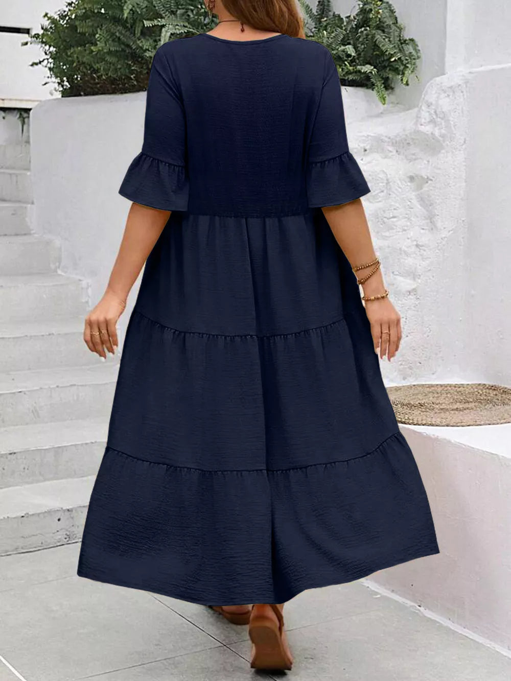 Navy blue midi dress with ruffle sleeves and tiered skirt