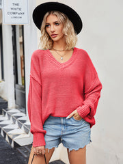 Oversized slouch knit V-neck sweater in coral with ribbed cuffs and hem.