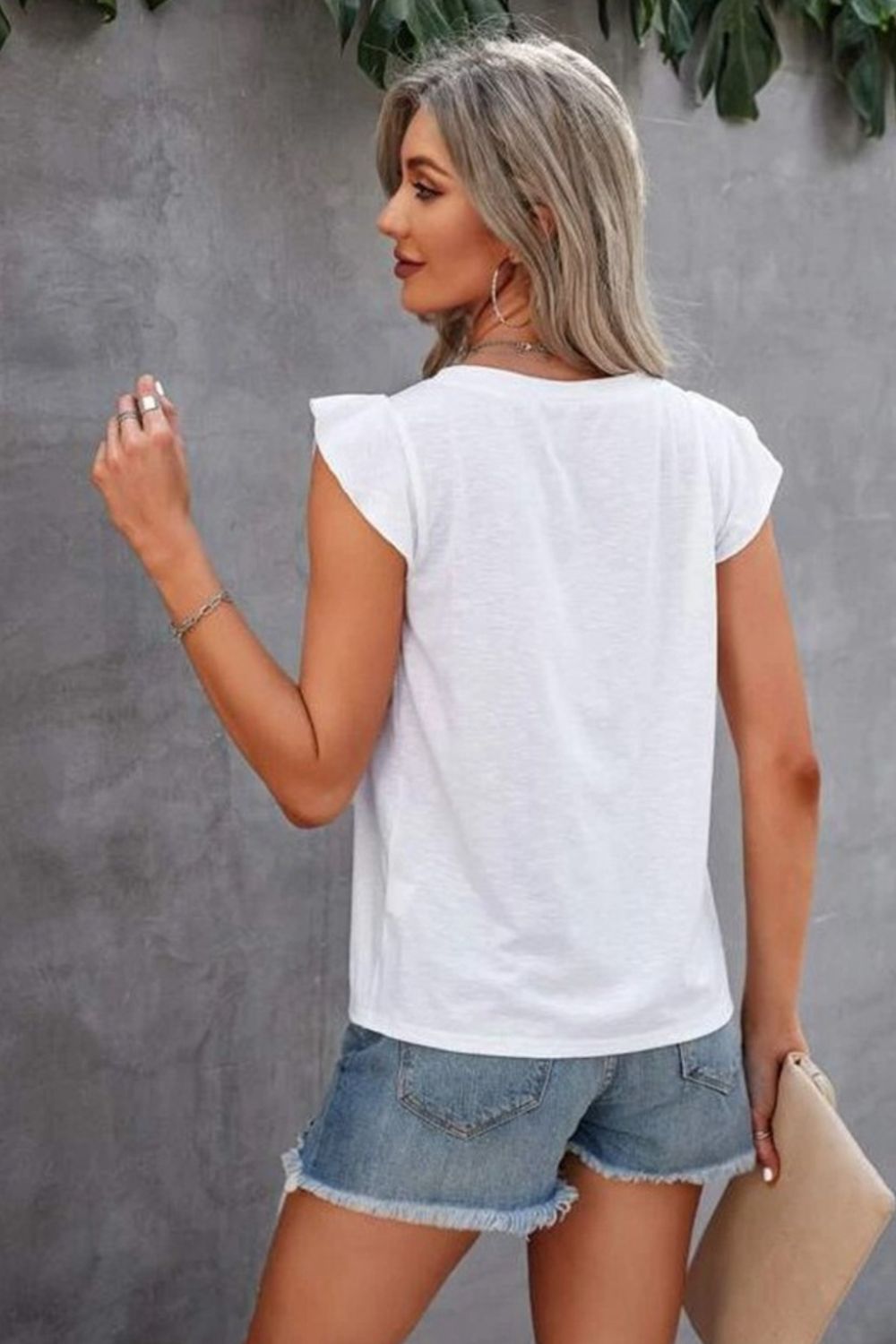 White cotton eyelet yoke flutter sleeve top with frayed denim shorts