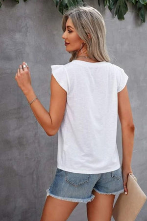 White cotton eyelet yoke flutter sleeve top with frayed denim shorts