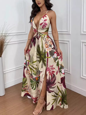 Maxi dress with tropical print, plunging neckline, cutout waist, decorative ring, and high slit.