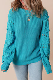 Turquoise knit sweater with textured cutout sleeves and crew neck.