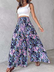 Bohemian print wide leg pants with smocked waist in purple, pink, and blue.