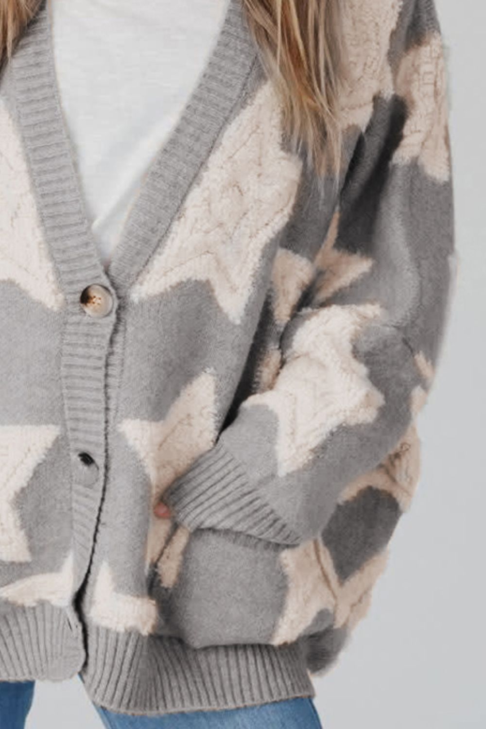 Gray starburst knit cardigan with textured details and button front.