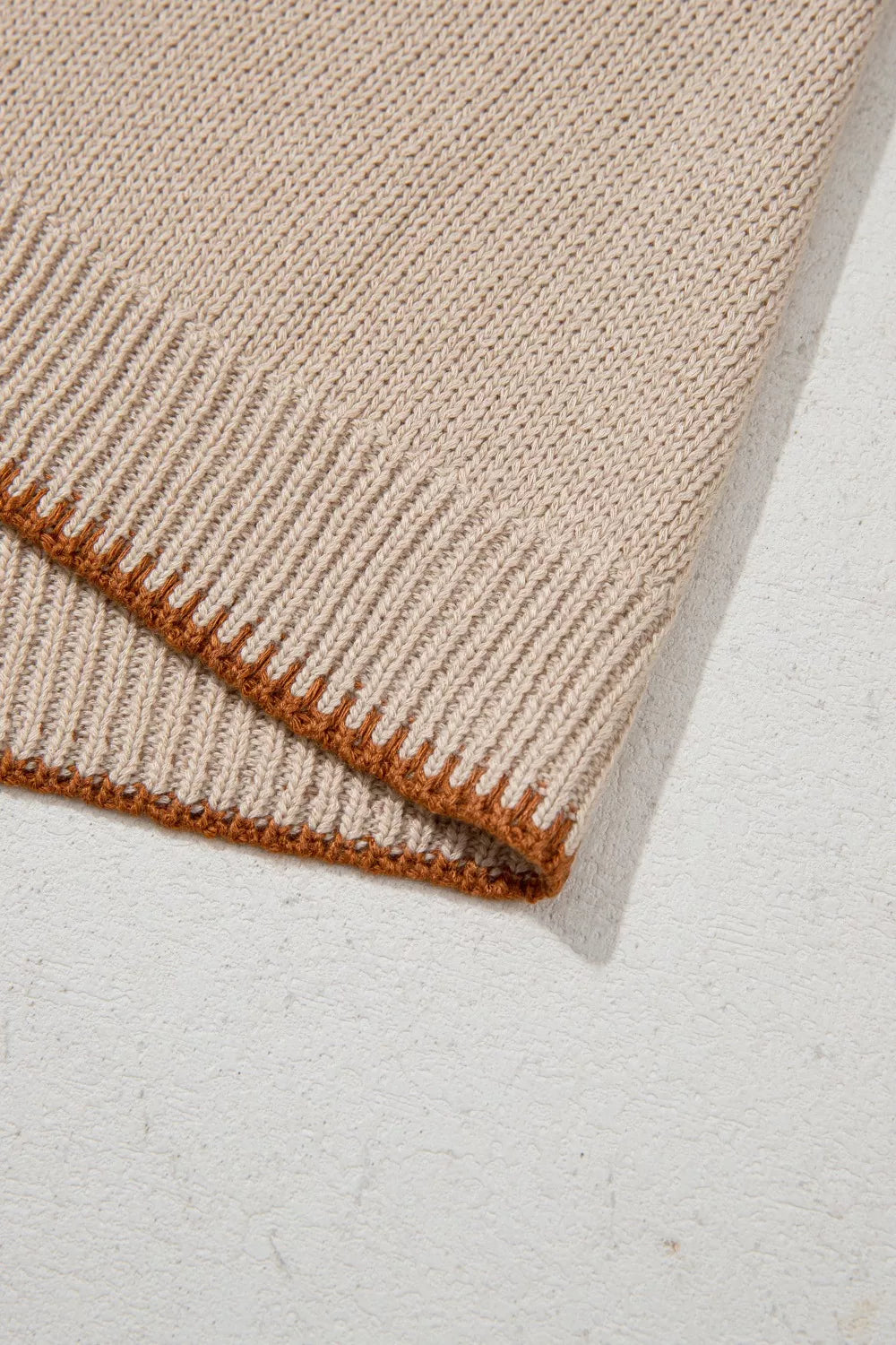 Howdy Textured Knit Sweater Vest in beige acrylic with brown trim detail