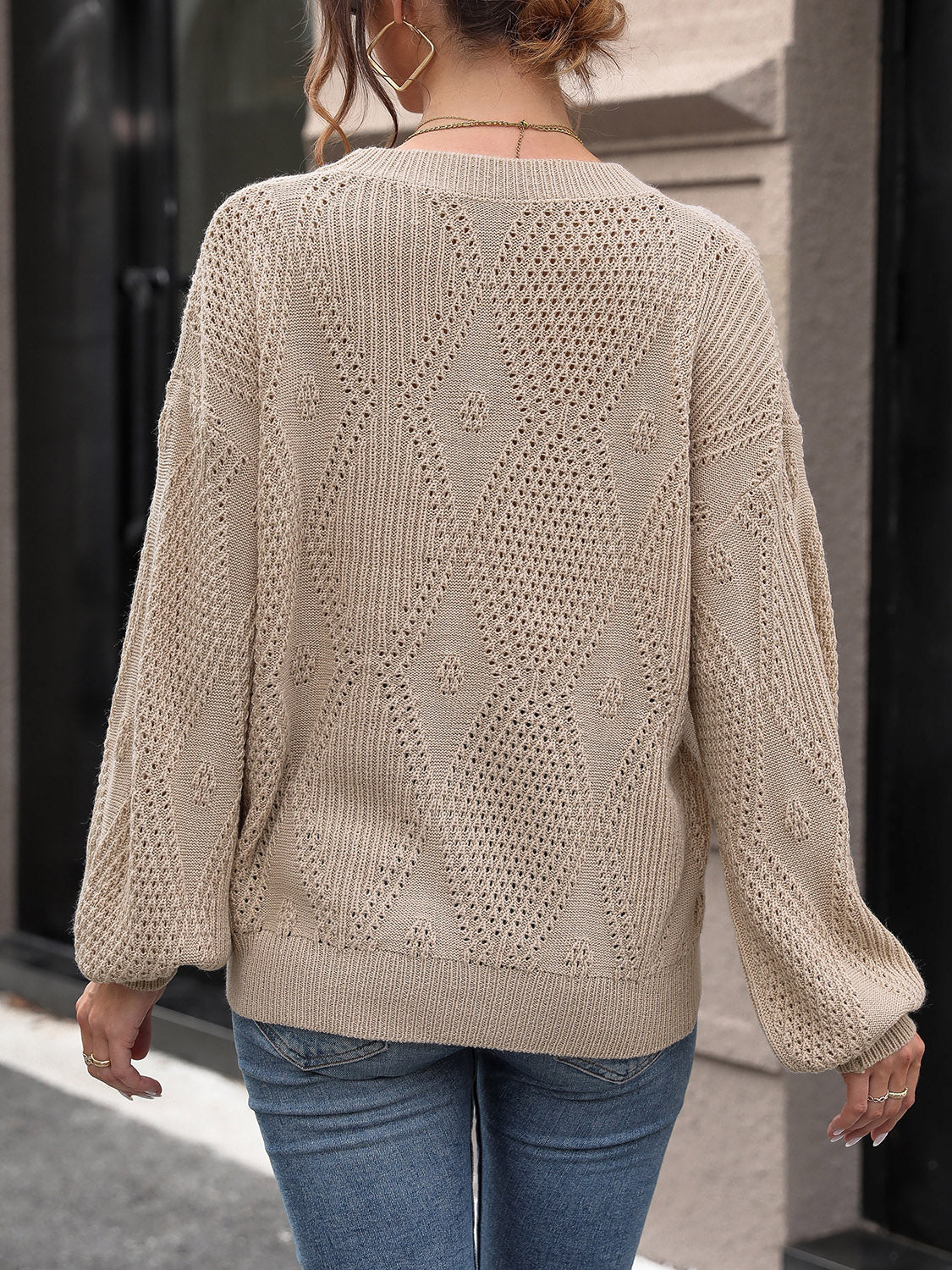 Camel diamond lattice knit sweater with balloon sleeves and open knit details.