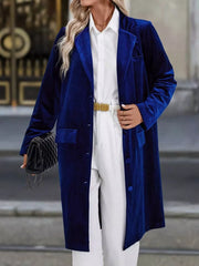 Elegant longline trench coat in dark blue velvet with lapel collar and buttoned front.