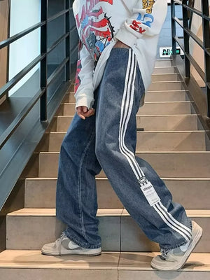 Men's blue oversized wide-leg jeans with white side stripes and a casual fit.