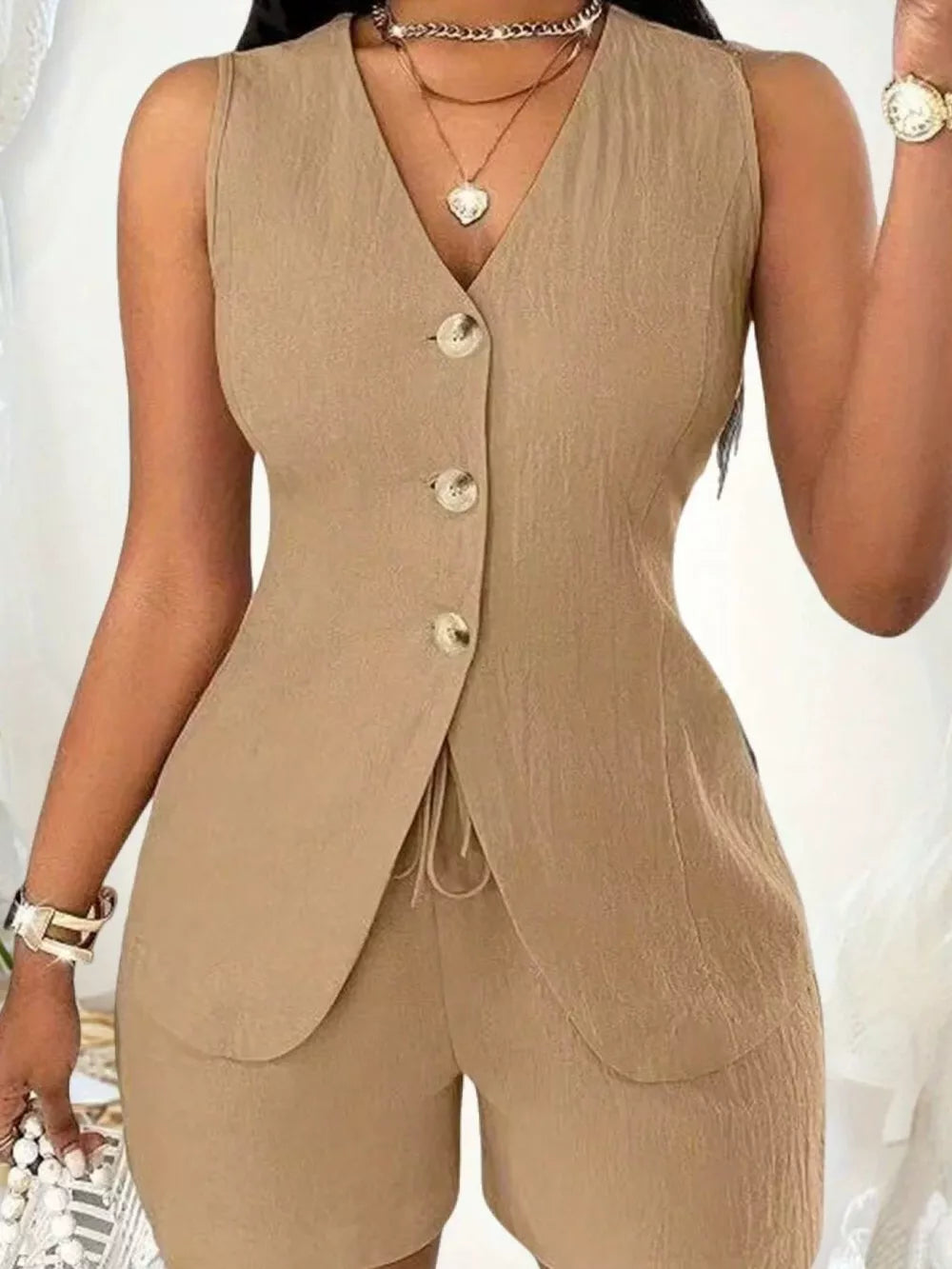 Tan button-down vest and shorts set with drawstring detail.