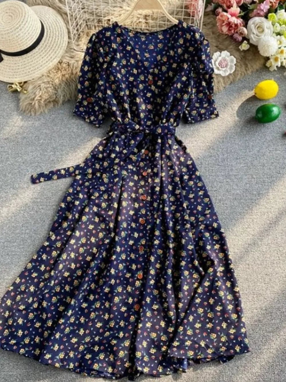 Dark blue floral V-neck midi dress with short sleeves, button front, and belted waist
