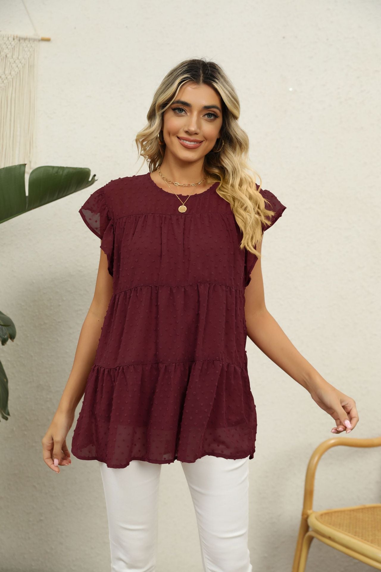 Swiss dot flutter sleeve tiered blouse in Brick Red with round neckline.