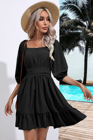Black mini dress with square neck, puff sleeves, belted waist, and ruffled hem.