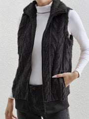 Black faux fur zip-up vest with chevron pattern and pockets.