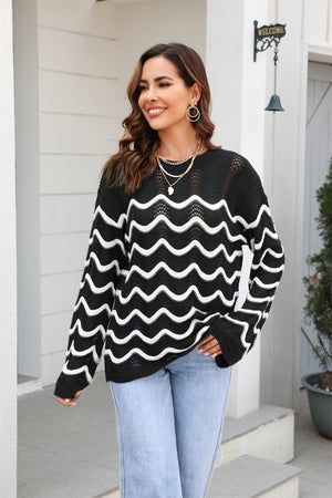 Black wavy knit openwork sweater with white wave pattern and crew neck.
