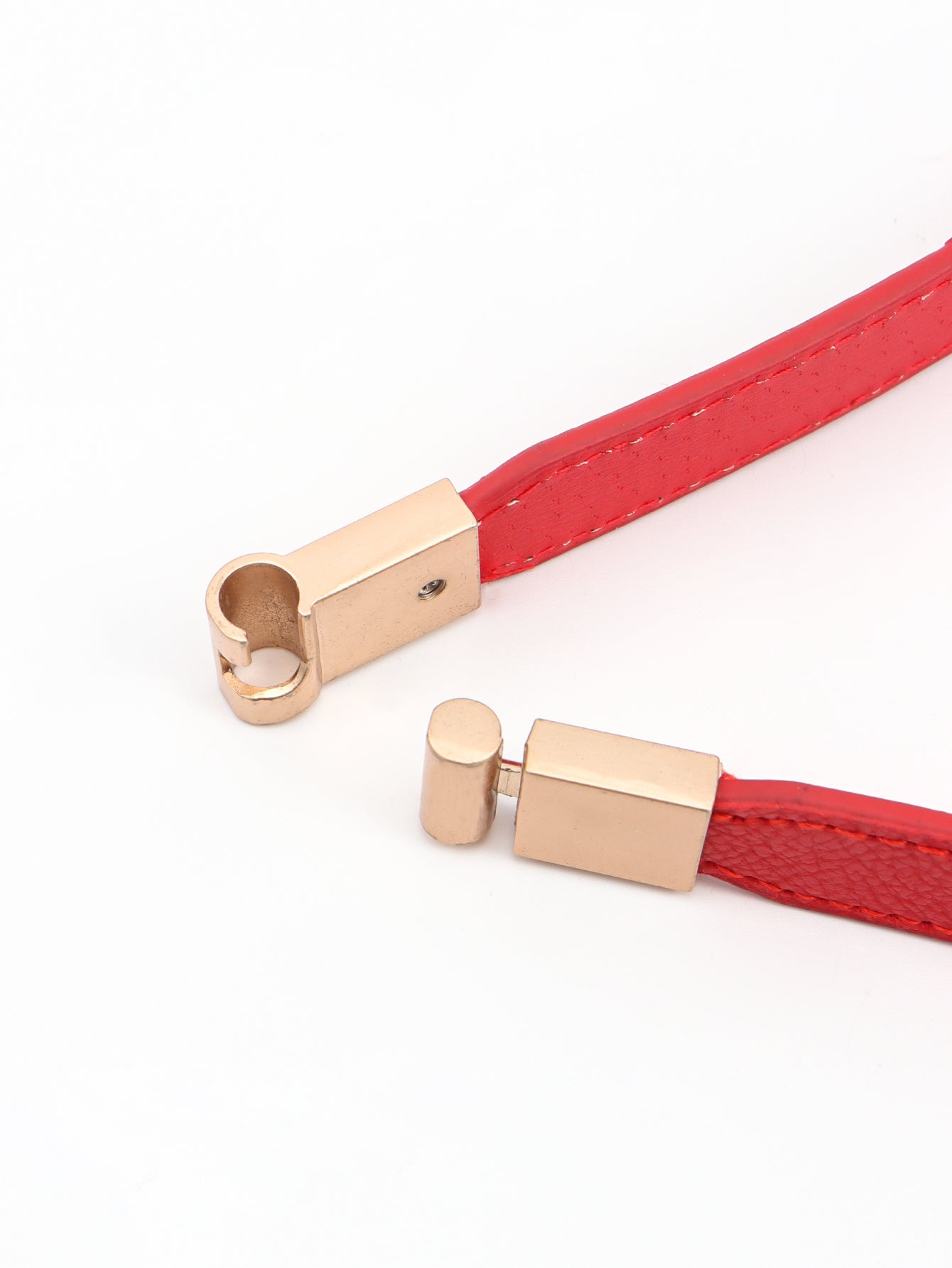 Red elasticated belt with gold buckle detail and leather trim